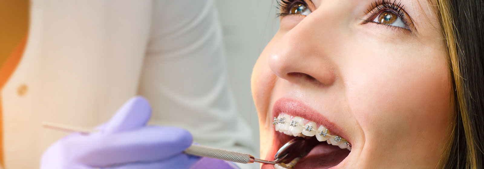 A Dentist checking orthodontic braces