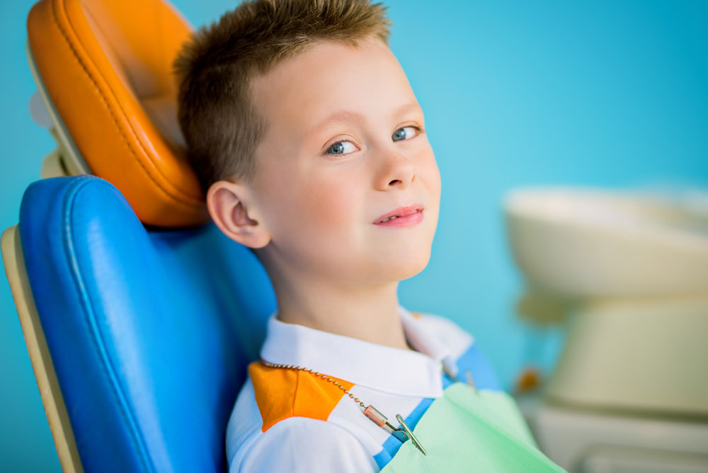 A Kid at sitting on dental chair