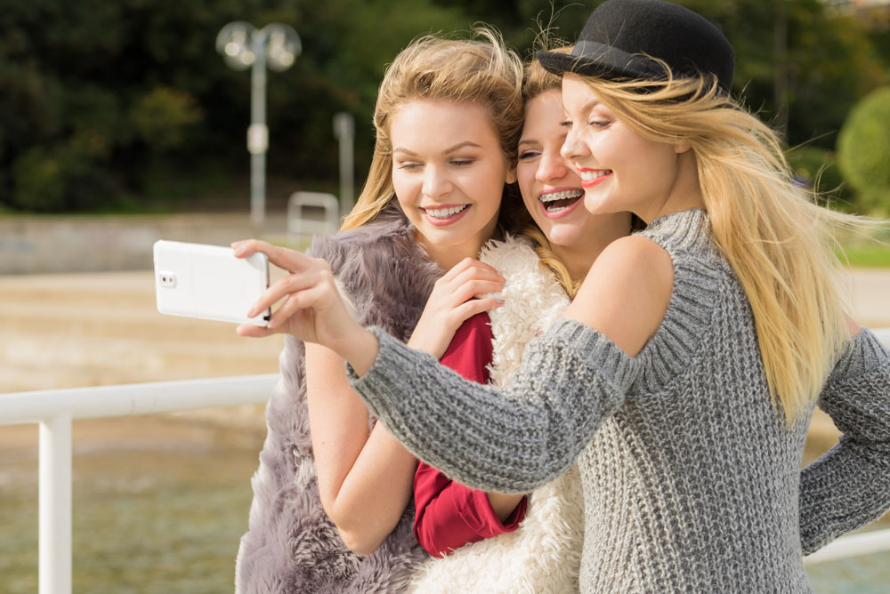 Three women taking selfie outdoor